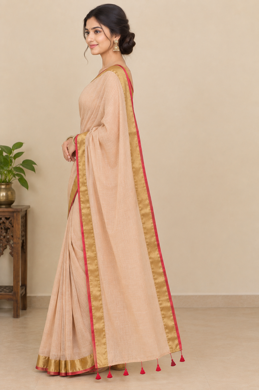 Peach Beige Cotton Saree with Golden Zari Border & Red Tassel Detailing
